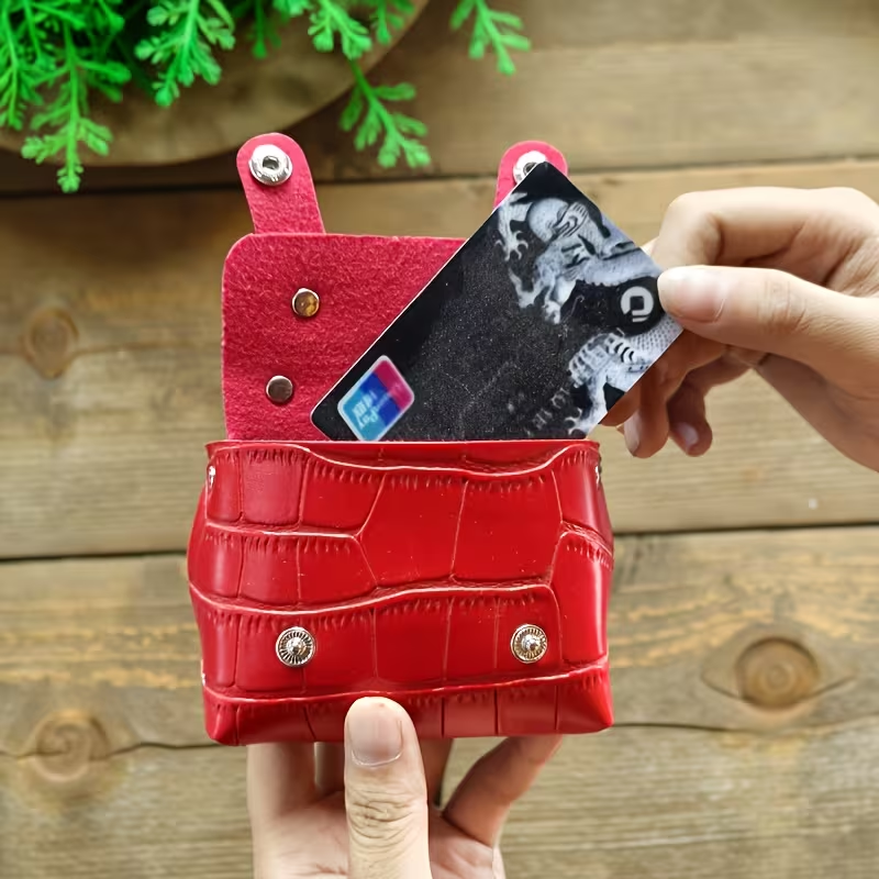 Red mini briefcase purse open showing card slot with credit card being inserted